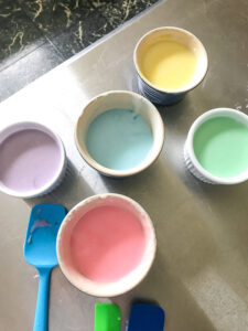 Pretty pastel icing in pink, green, yellow, blue, and purple to decorate the spring sugar cookies