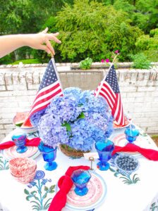 American flag centerpiece with blue hydrangea in wicker vase