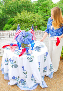 Katherine sets patriotic table with red and blue china, Fostoria goblets, and hydrangea centerpiece