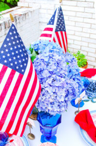 Vibrant blue hydrangea July 4th centerpiece with US flags