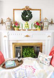 Grandmillennial mantel decor with magnolia wreath, lemon topiary, and fresh florals