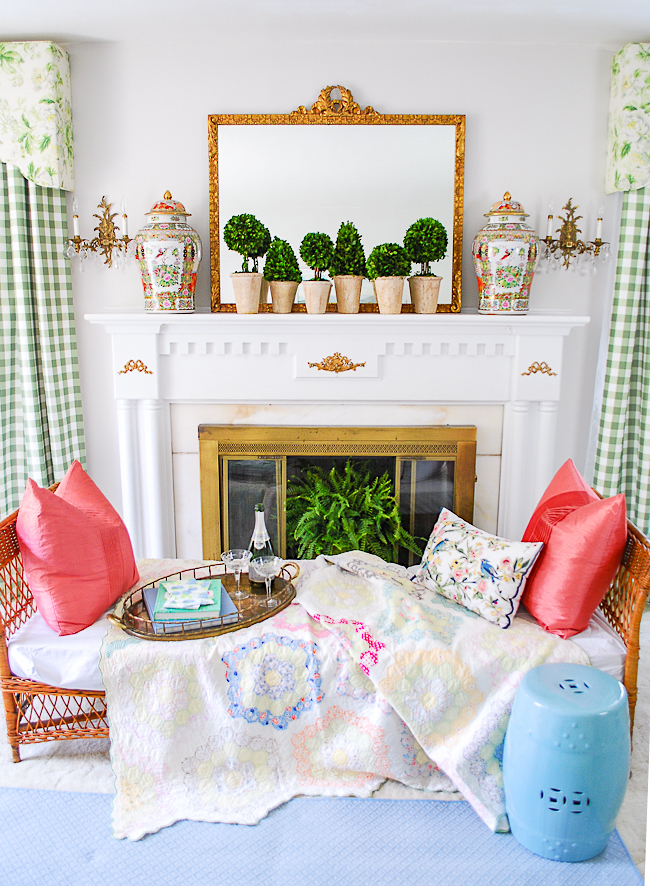 Full view of grandmillennial mantel and fireplace with wicker daybed in front