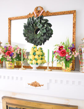 Natural elements with a magnolia wreath and fresh florals play a major role on this mantel