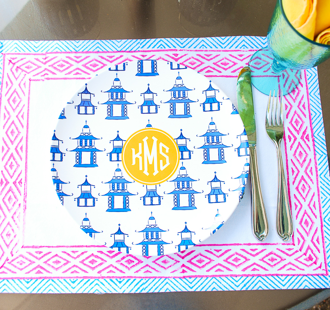 Colorful summer place setting with Indian block print placemat, pagoda monogrammed plate, and aqua goblet