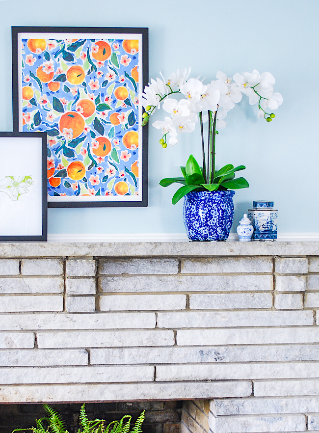Asymmetrical arrangement with faux orchids and blue and white ginger jars