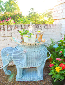Blue wicker elephant stand set up as bar with tray and mojitos on top
