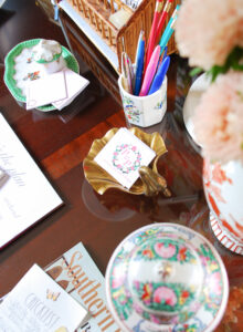 Vintage trays, pen cup, and caddies for organizing desk. Creating a pretty home office helps your stay producing when working from home.