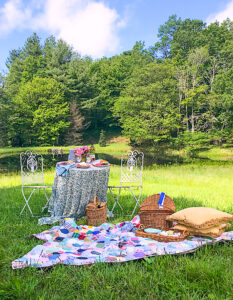 Picnic blanket and table set up for some romantic al fresco dining in the mountains