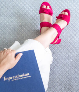 A pair of sassy pink sandals from Sarah Flint against blue rug