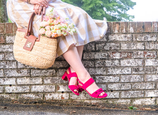 Katherine of Pender & Peony sitting on brick wall in the Nadia pink sandal from Sarah Flint