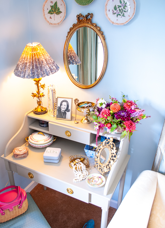 Vintage vanity styled with gilt mirror, tole floral lamp, and jewelry boxes