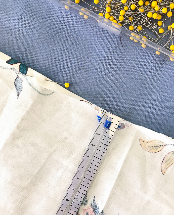 Using a sliding gauge hem ruler measure out and fold your fabric down 1/4"