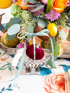 silver basket with ribbon bow and mini pumpkins