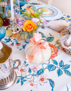 White faux pumpkin with pink bow topper