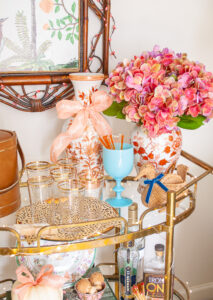 portieux vallerysthal aqua goblet and a collection of coral Chinese floral jars on bar cart