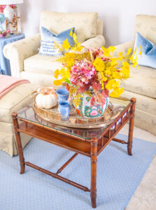 Coffee table with vintage brass tray and fall floral arrangement