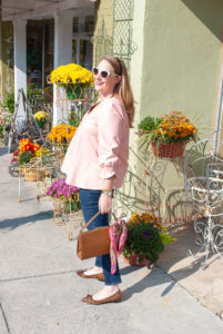 Katherine in pink Easton faux leather top, dark wash jeans, and leopard print flats - Natalie from Sarah Flint standing on sidewalk