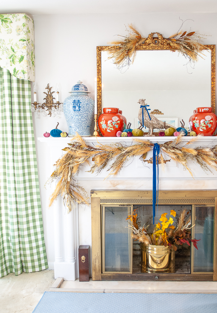 Autumn mantel decor with ginger jars and velvet pumpkins