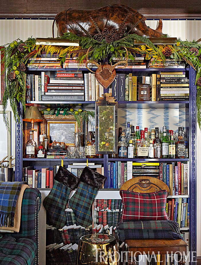 Library shelves decked for the holidays in plaid - Scot Meacham Wood Designs for Traditional Home Magazine
