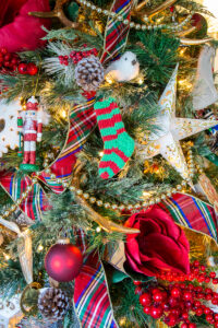Handmade heirloom mini stocking from my great-grandmother is a cherished ornament on our traditional Christmas tree