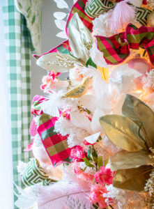 Detail view of white Christmas tree decorated in pink and green Chinoiserie