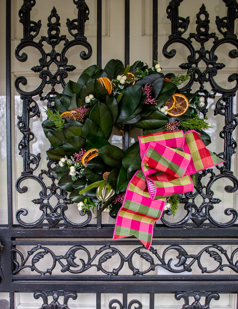 Williamsburg style wreath with pink and green gingham bow on Katherine's black iron front door