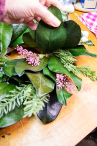 Heather picks added into magnolia and citrus Christmas wreath