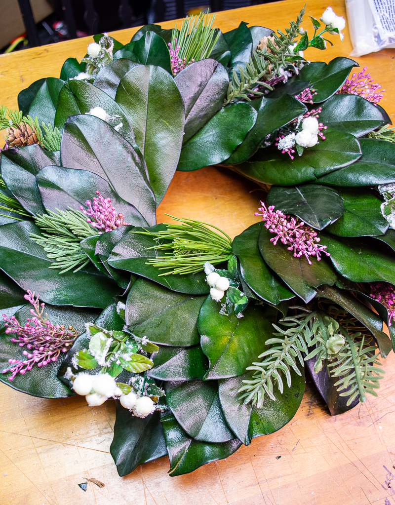 Preserved magnolia wreath with added heather, sugar berries, and evergreen sprigs