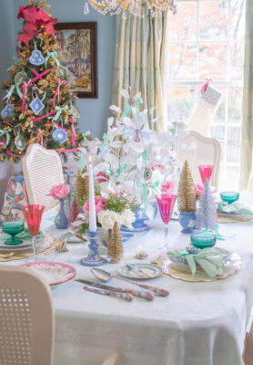 Dreamy pastel Christmas table in Jasperware and jewels with white paper tree centerpiece, Wedgwood vases, pink goblets, green coupes, antique china, and vintage jewelry ornaments