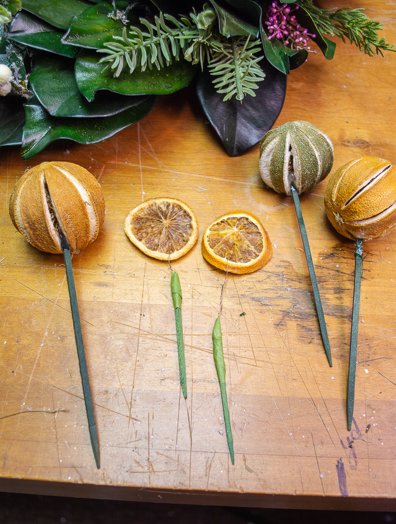 Several citrus slice picks and pomander picks ready to add to wreath