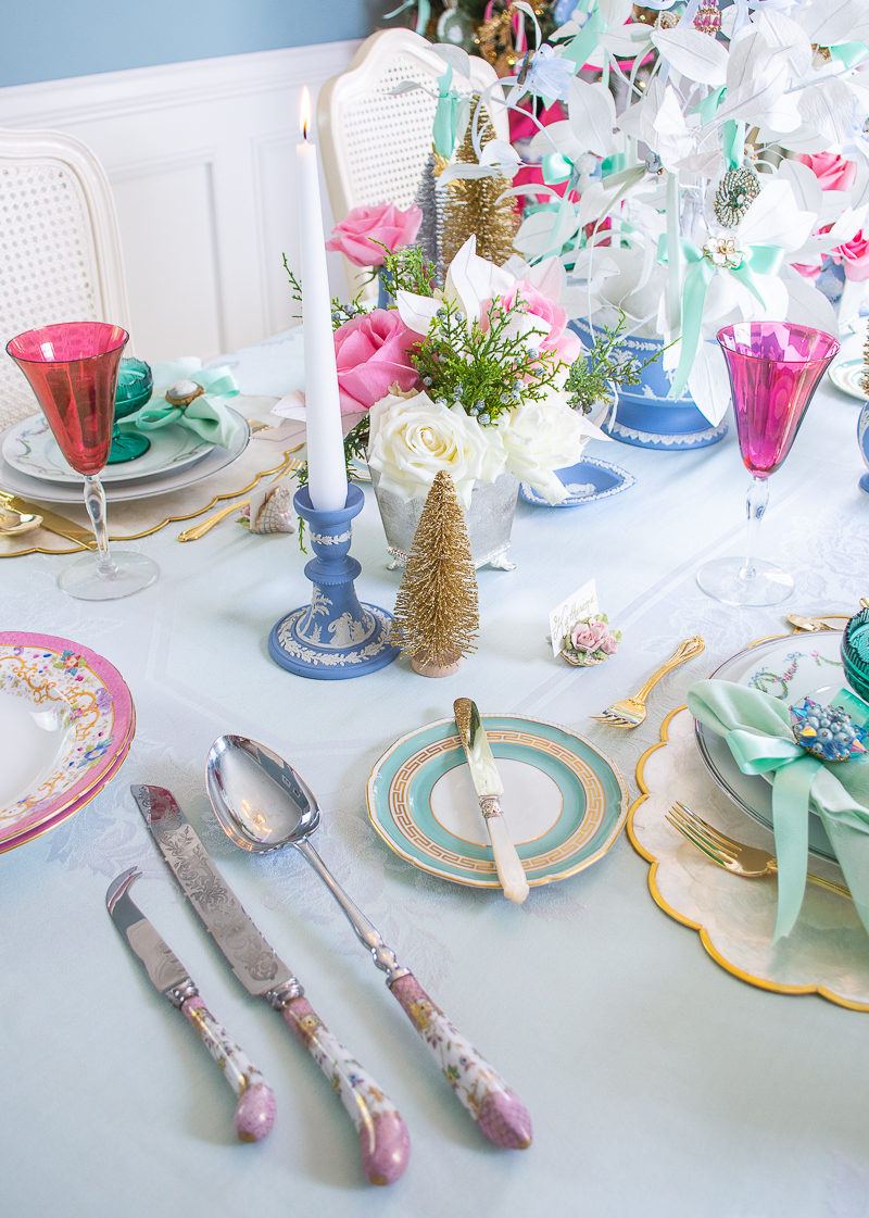 Side view of vintage and antique tableware on dreamy pastel Christmas tablescape