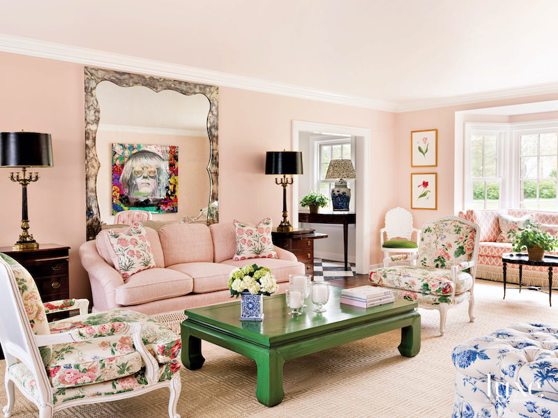 Pink living room with high contrast blacks, browns, and emerald green