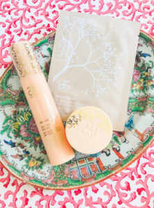 Arbonne products part of my winter skin care routine laid on Rose Medallion plate with pink background
