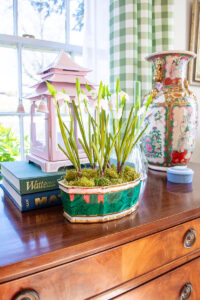 Malachite planter with snowdrops on traditional sideboard - classic green accessory
