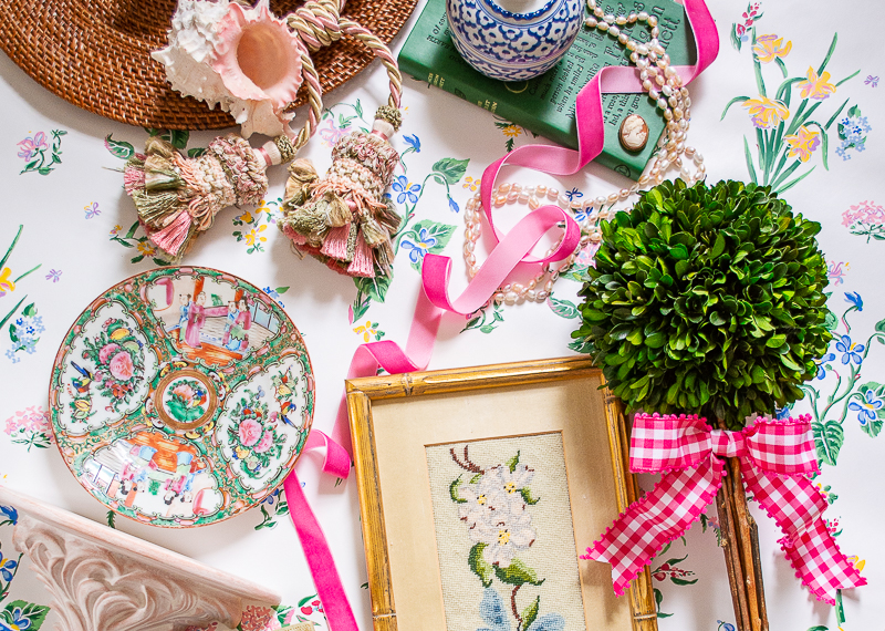 Flatlay with grandmillennial decor showcasing how to decorate with pink