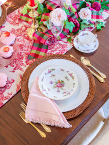 Dresdenia china floral design with roses and tulips set on white plate with rattan charger and pink napkin