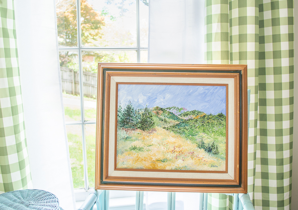 Mountain landscape painting propped in front of window - artwork inspired my deeper thinking about going green