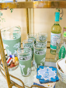 Green Jeanette Jasperware style high ball glasses and pitcher on bar cart