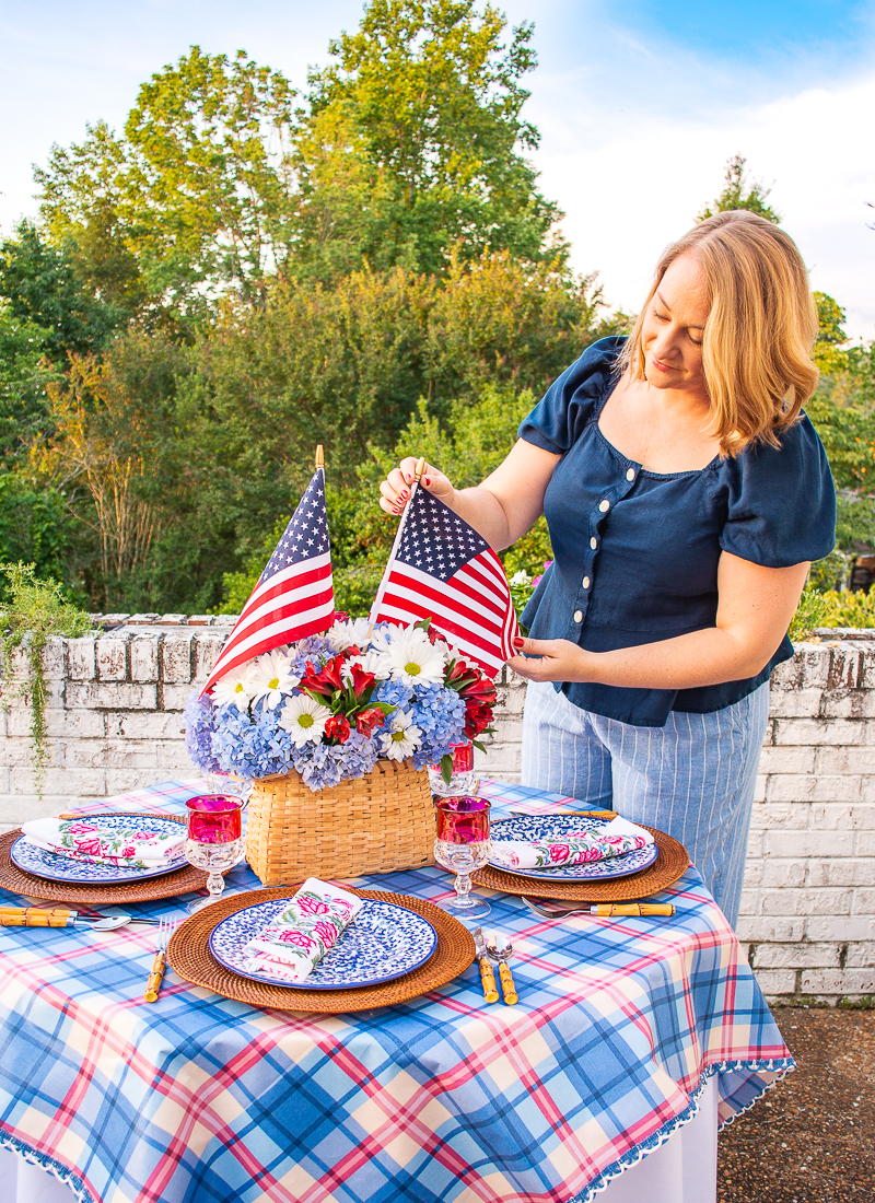 Katherine fixes American flag in floral centerpiece for Independence Day table