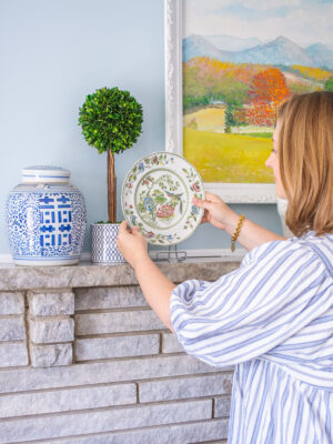 Katherine places Chinoiserie plate on mantel to complete the look