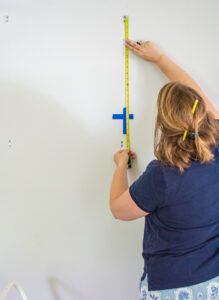 Katherine measures between hooks for works of art in botanical grid gallery wall