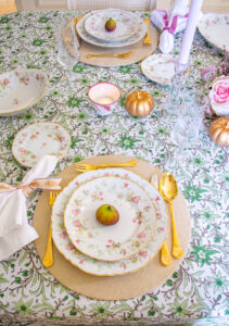 Hutschenreuther Bavarian china on green and white Indian block print tablecloth with gold flatware and linen napkin