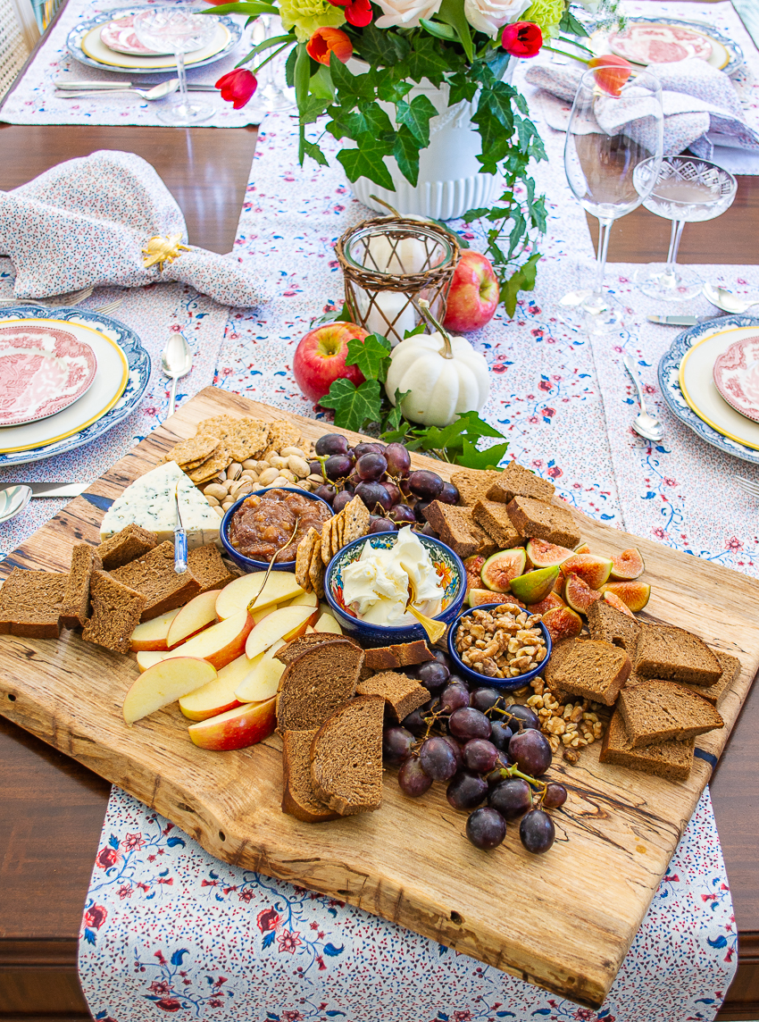 Autumn cheese board with figs, grapes, apples, and marscapone
