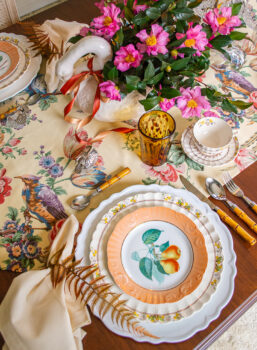 Thanksgiving place setting mixing Mottahedeh fruit plates with Spode's Wicker Dell china, tortoise shell glasses, and bamboo flatware