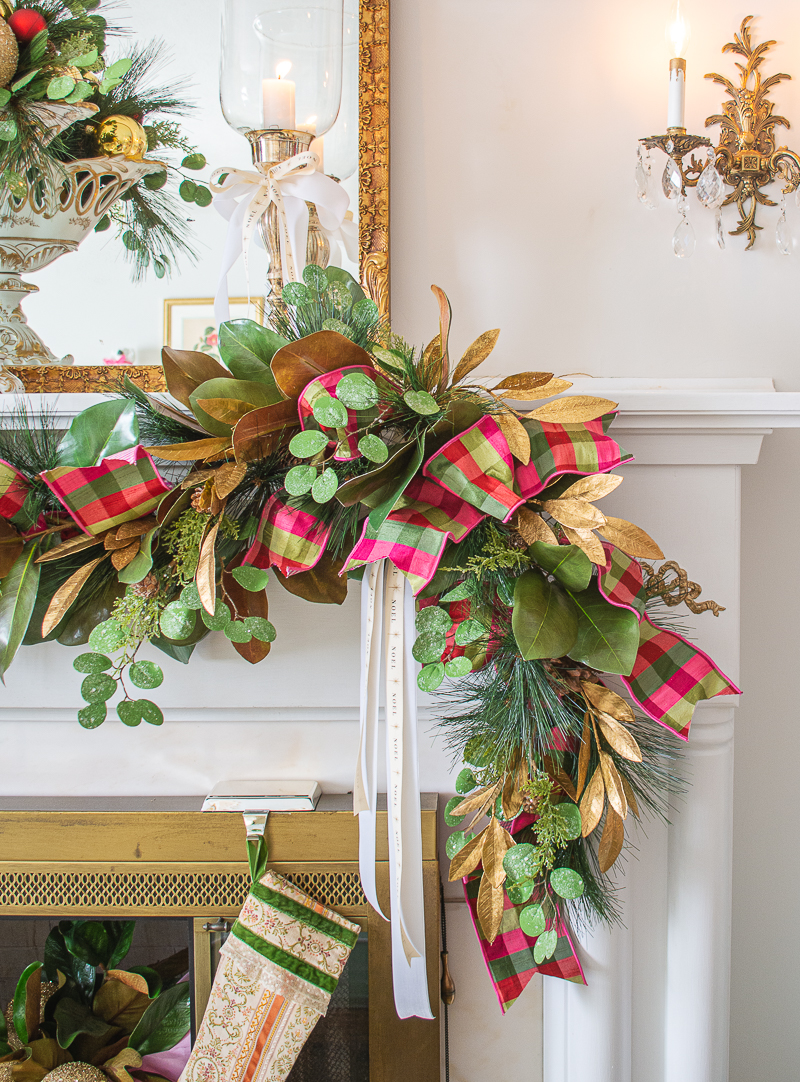detail view of magnolia pine garland with eucalyptus and cedar intertwined with pink and green plaid ribbon