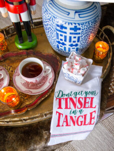 Coffee table set with brass tray cider and treats with a "Don't get your tinsel in a tangle" tea towel