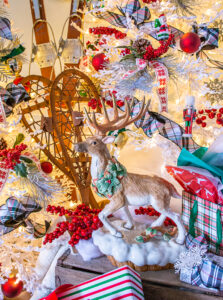 Fitz & Floyd reindeer on crate in front of Christmas trees for that après ski vibe