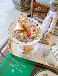 Vintage ornaments nestle in a pierced compote on the coffee table