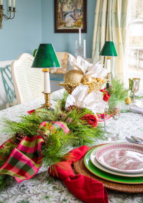 A simple Christmas table garland with faux pine, magnolia, and plaid ribbon