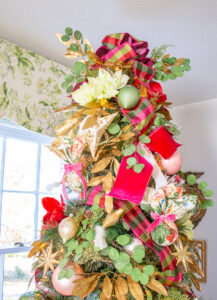 Grandmillennial Southern Christmas tree topped with plaid bow